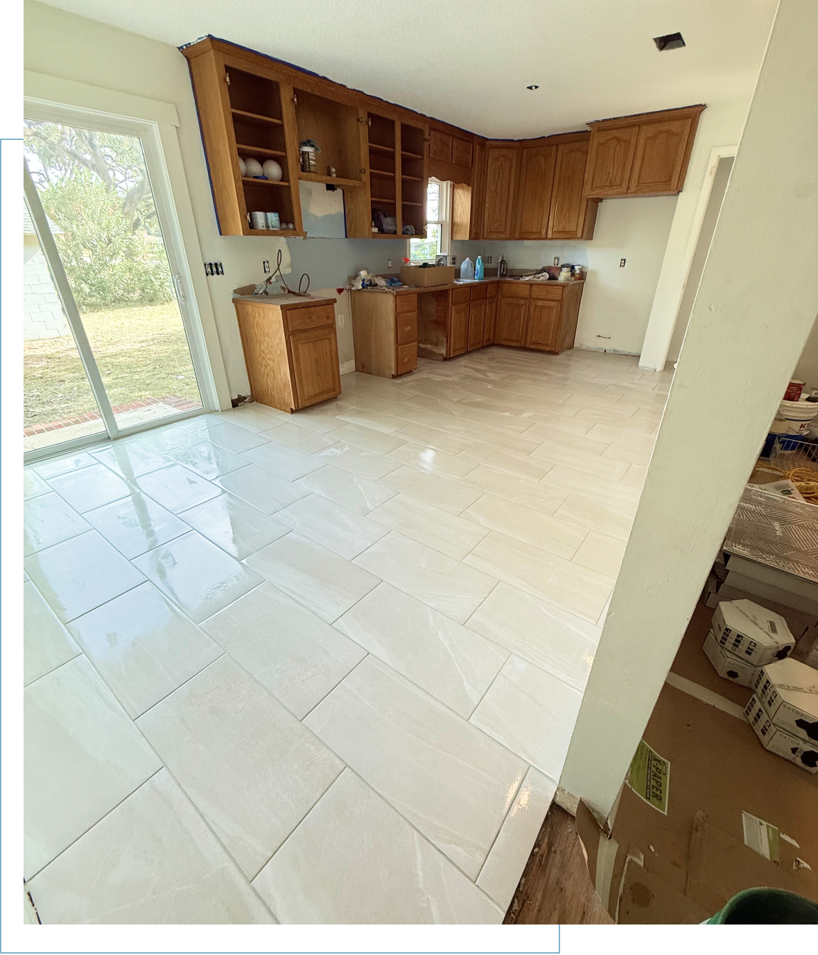 Kitchen renovation with new tile flooring installed.